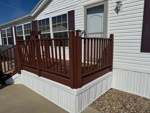 Deck makeover with wood railings and round aluminum spindles