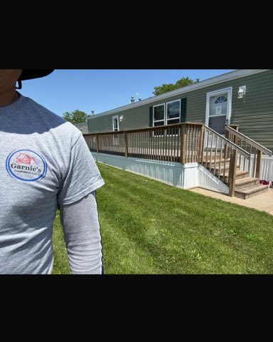 Stained deck beside a manufactured home